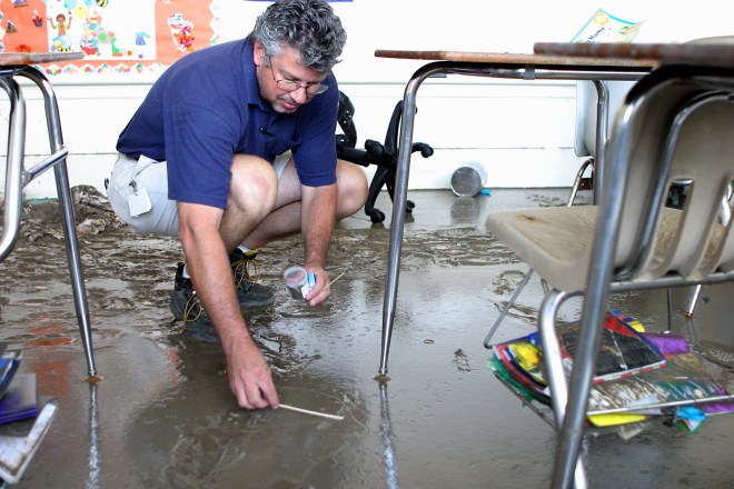 BAY ST. LOUIS, MS -- SEP 12, 2005: Gene Herring, Environmental Engineer with the Mississippi Department of Health takes a soil sample from the kindgergarten classroom at Secondary Elementary School in Bay St. Louis, MS on Monday September 12, 2005. Samples were collected to look for heavy metals and toxins. PHOTO: Ana Elisa Fuentes for The New York Times.